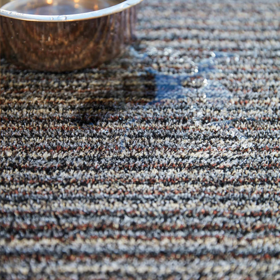 Textured brown and gray carpet with a woven pattern
