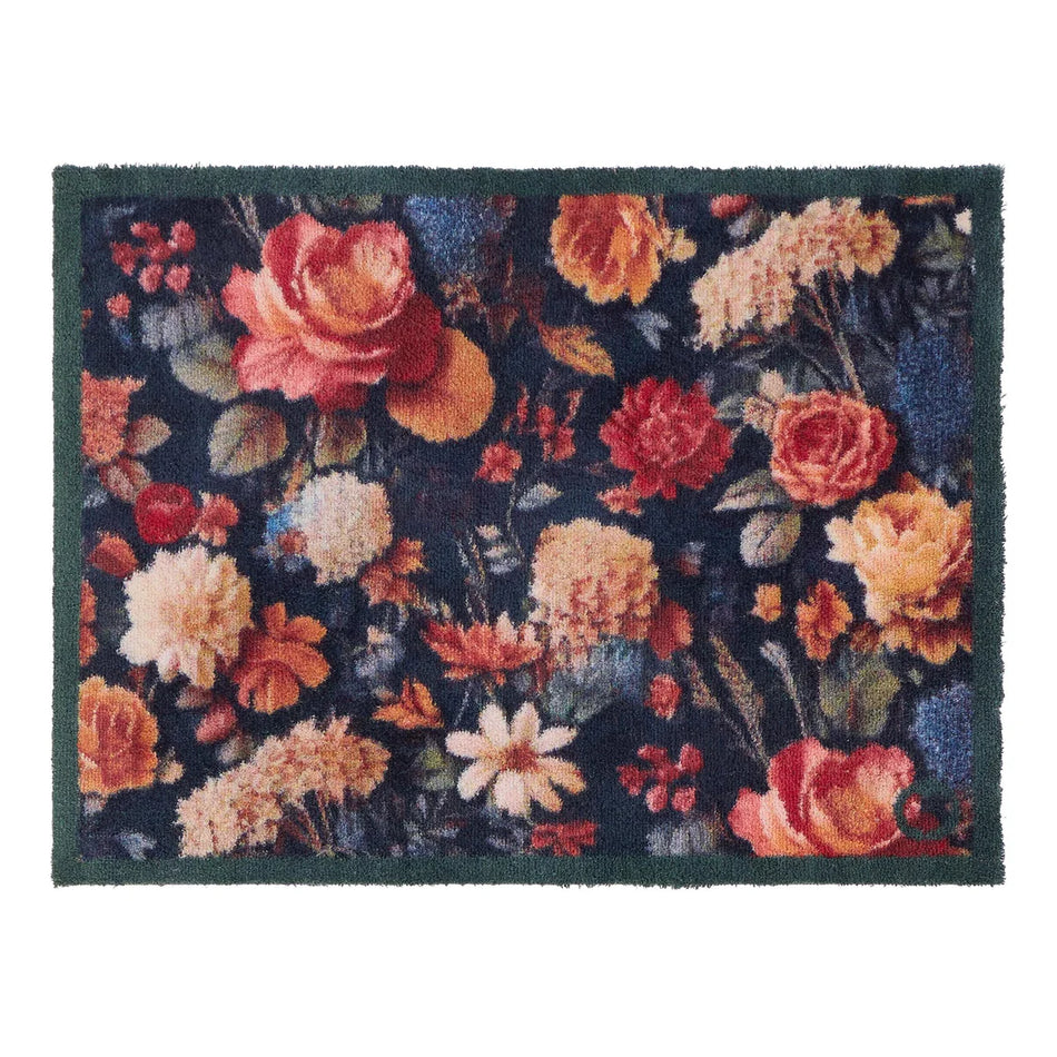 Floral patterned rug with vibrant colors on a dark background