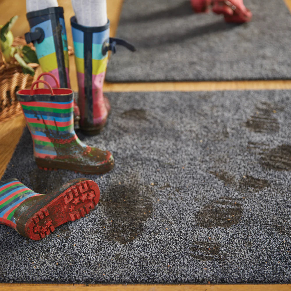 Hug Rug Plain Fleck Charcoal Barrier Mat placed at a modern doorway – Traps dirt and moisture effectively