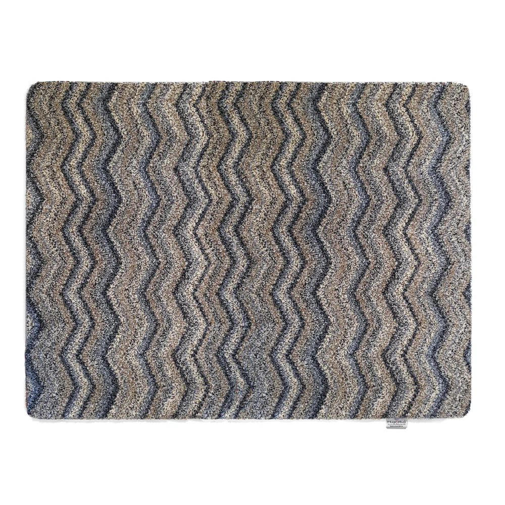 Hug Rug Ribbon Grey Zigzag mat with navy, beige, blue, and white pattern

