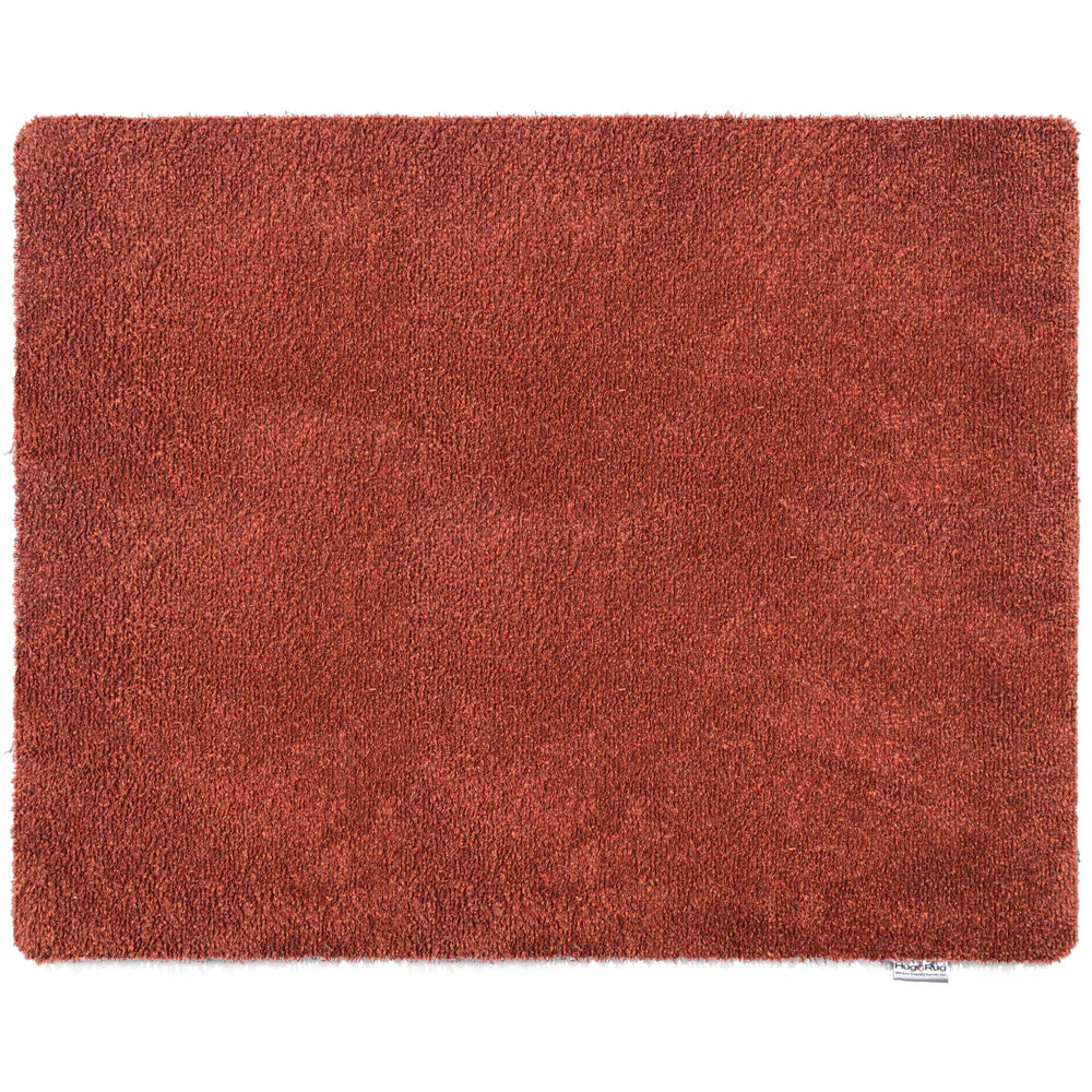 Red shaggy rug on a white background