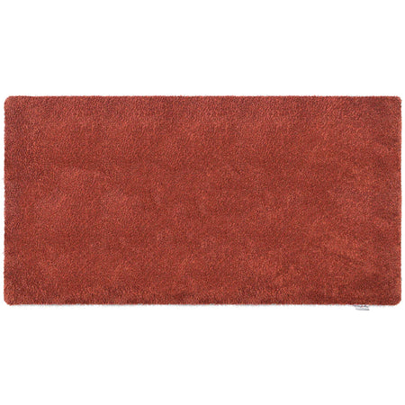 Rectangular red rug on a white background