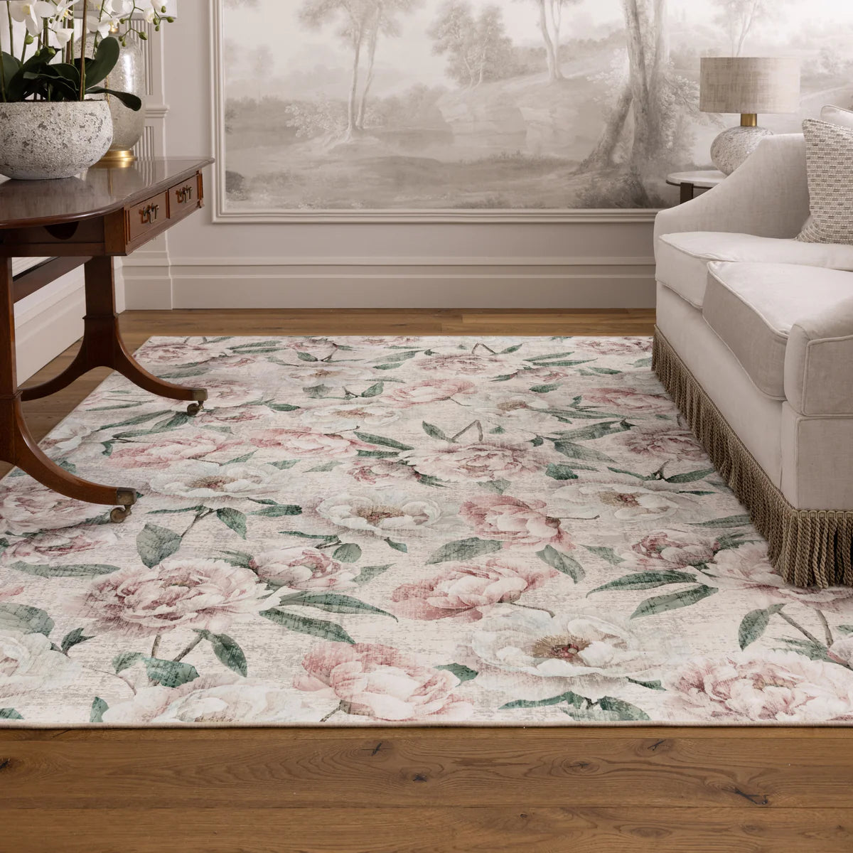 Floral patterned rug in a living room setting with a couch and table.