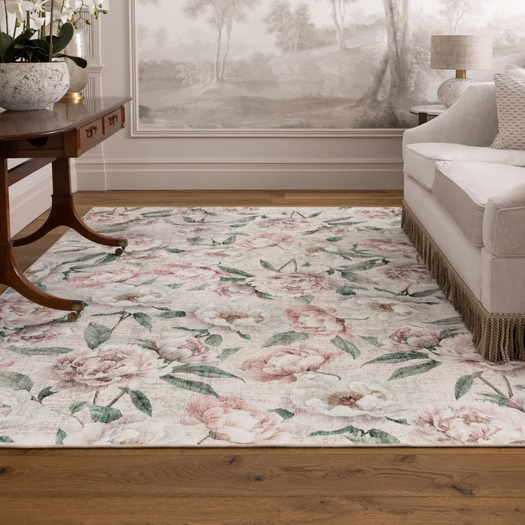 Floral patterned rug in a living room setting with a couch and table.