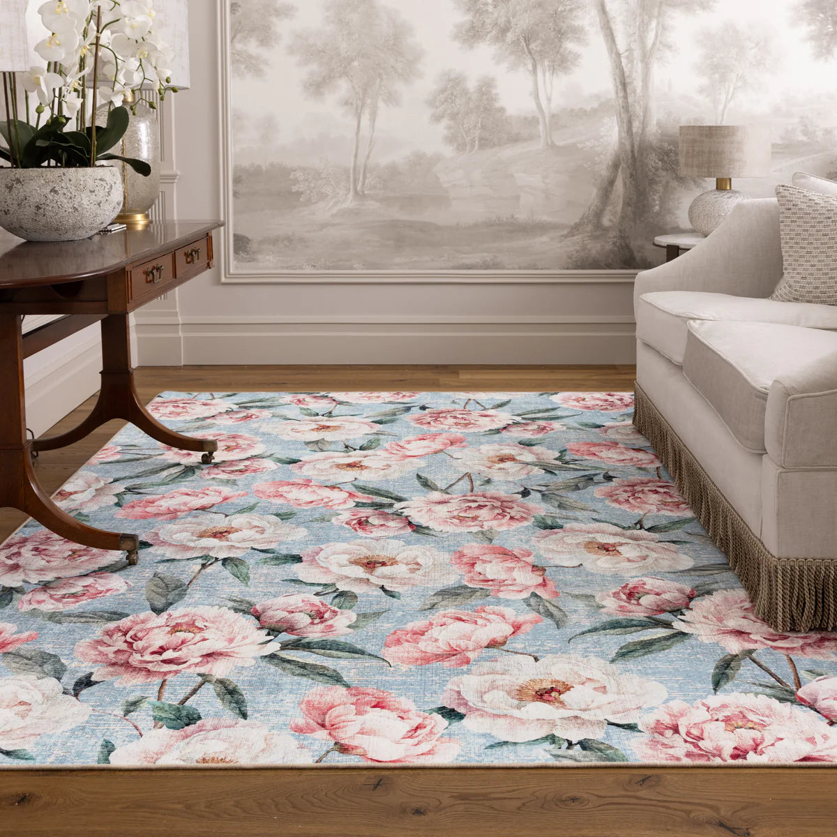 Floral patterned rug in a living room setting with a sofa and side table.