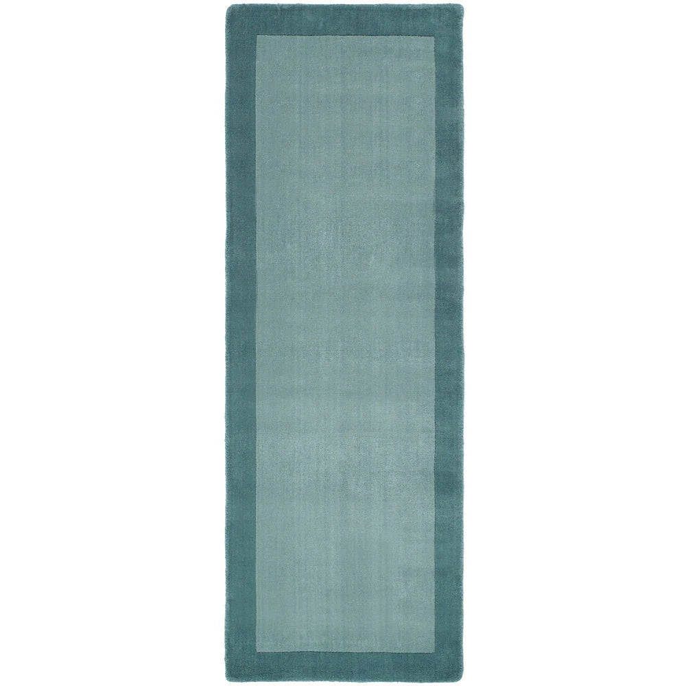 Rectangular teal rug with a solid color on a white background