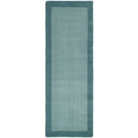 Rectangular teal rug with a solid color on a white background