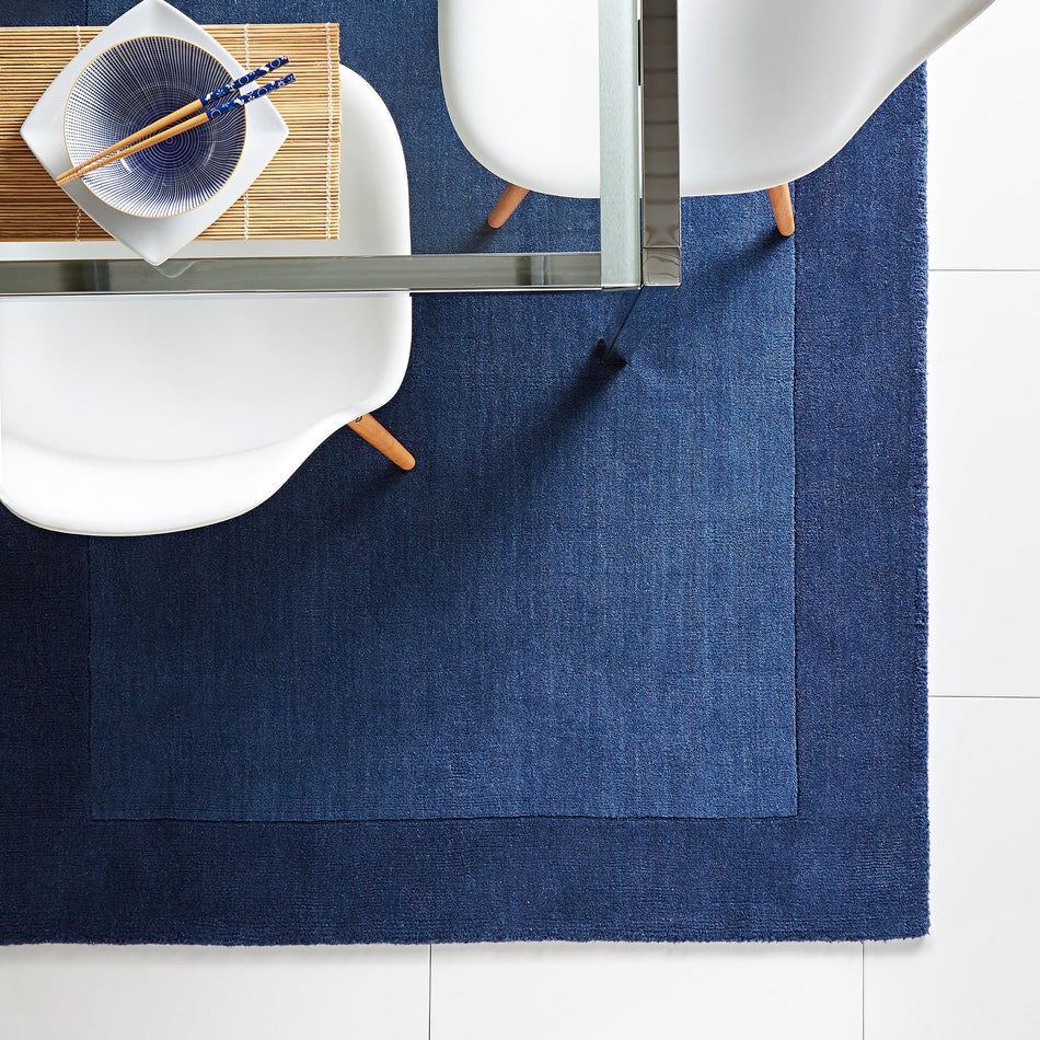 Hug Rug Origins Borders Navy wool rug in lounge
