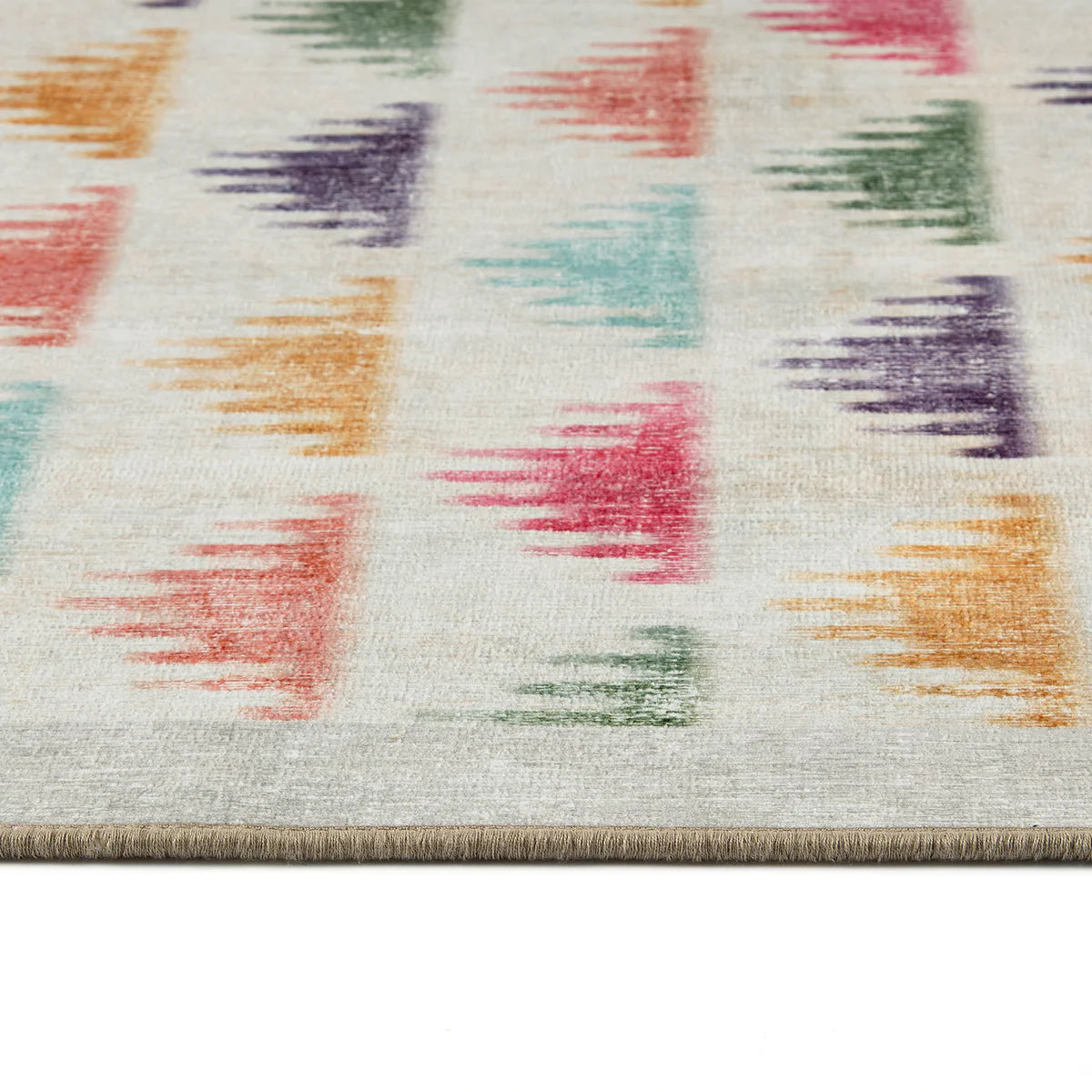 Multicolored abstract patterned rug on a white background