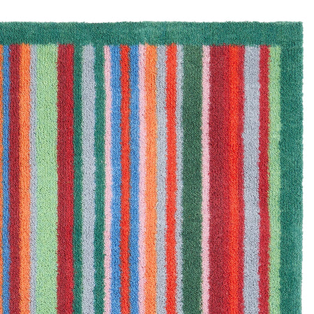 Striped rug with multicolor vertical stripes on a green background