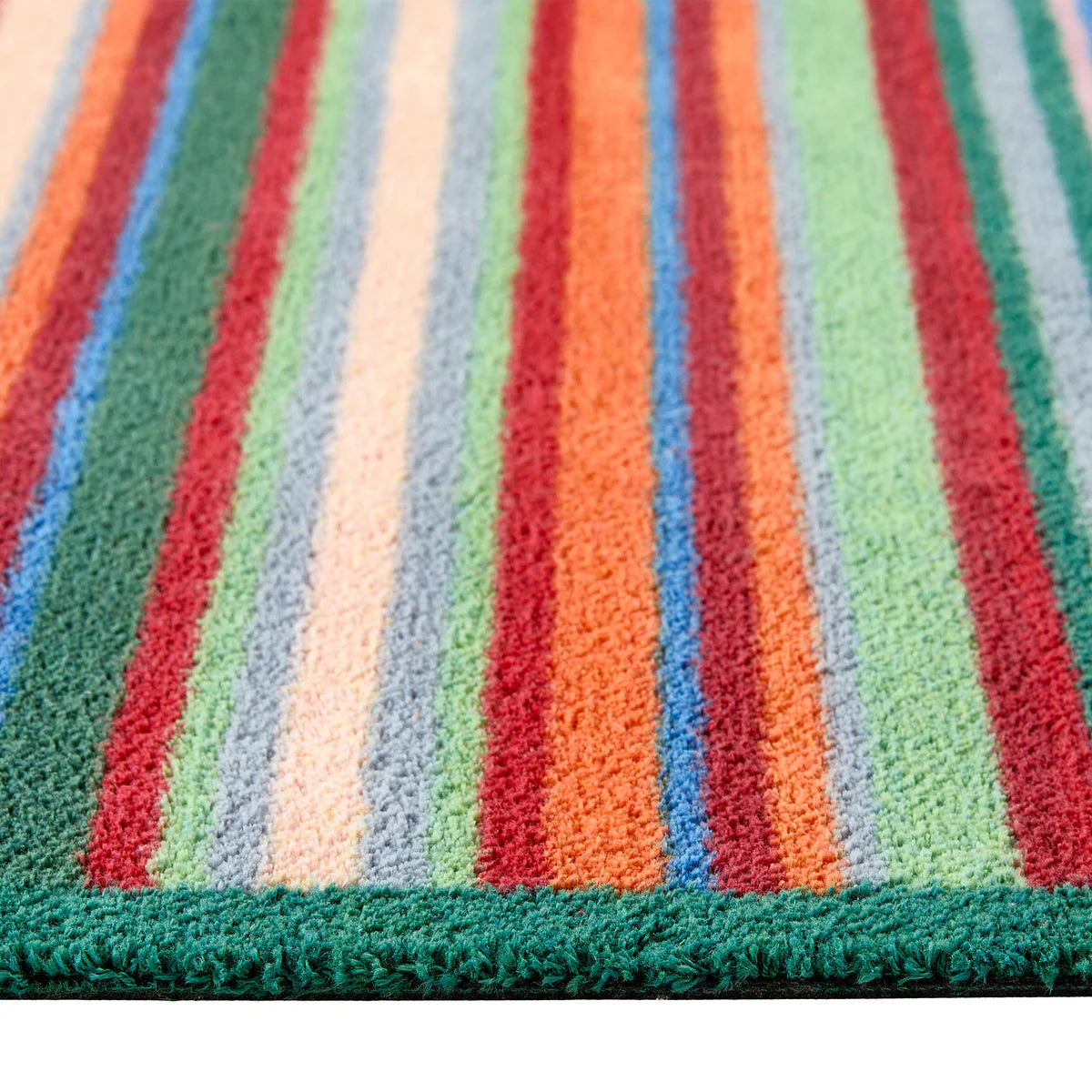 Close-up of a multicolored striped rug with green border