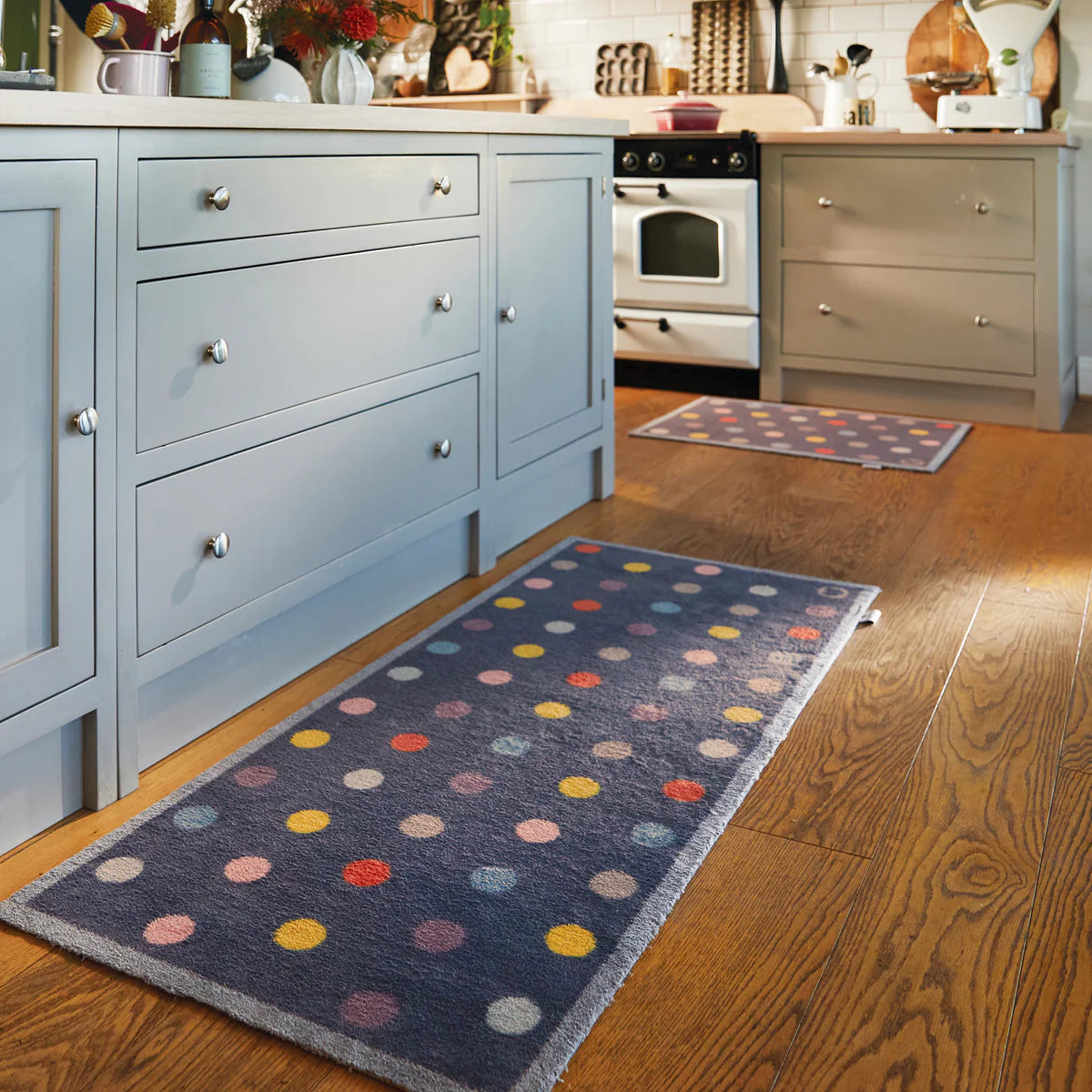 Kitchen with blue polka dot rug on wooden floor