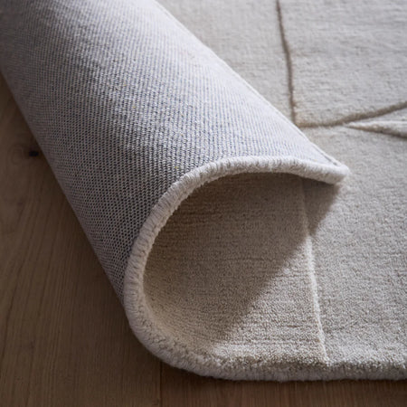 Close-up of a textured rug on a wooden floor