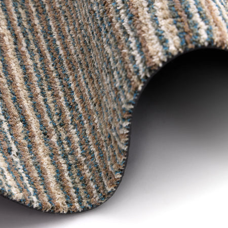 Close-up of a textured rug with brown, beige, and blue stripes on a white background.