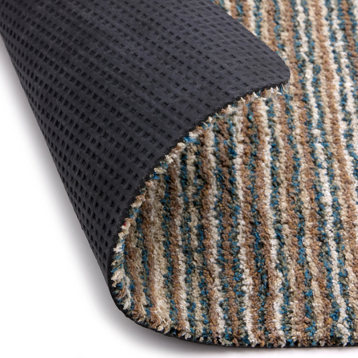 Close-up of a textured black mat and a striped multicolor rug corner.