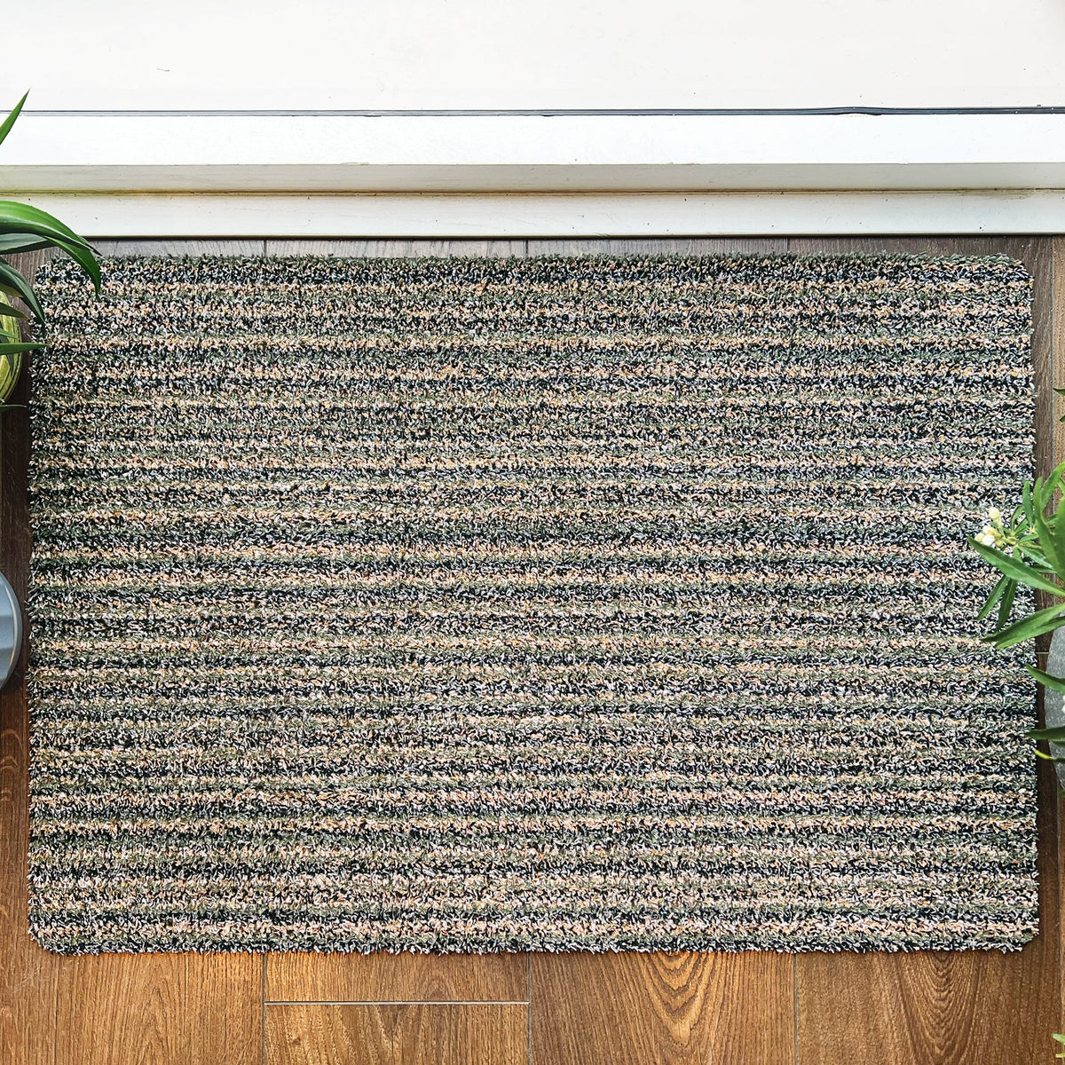 Close-up of Hug Rug soft sage green surface

