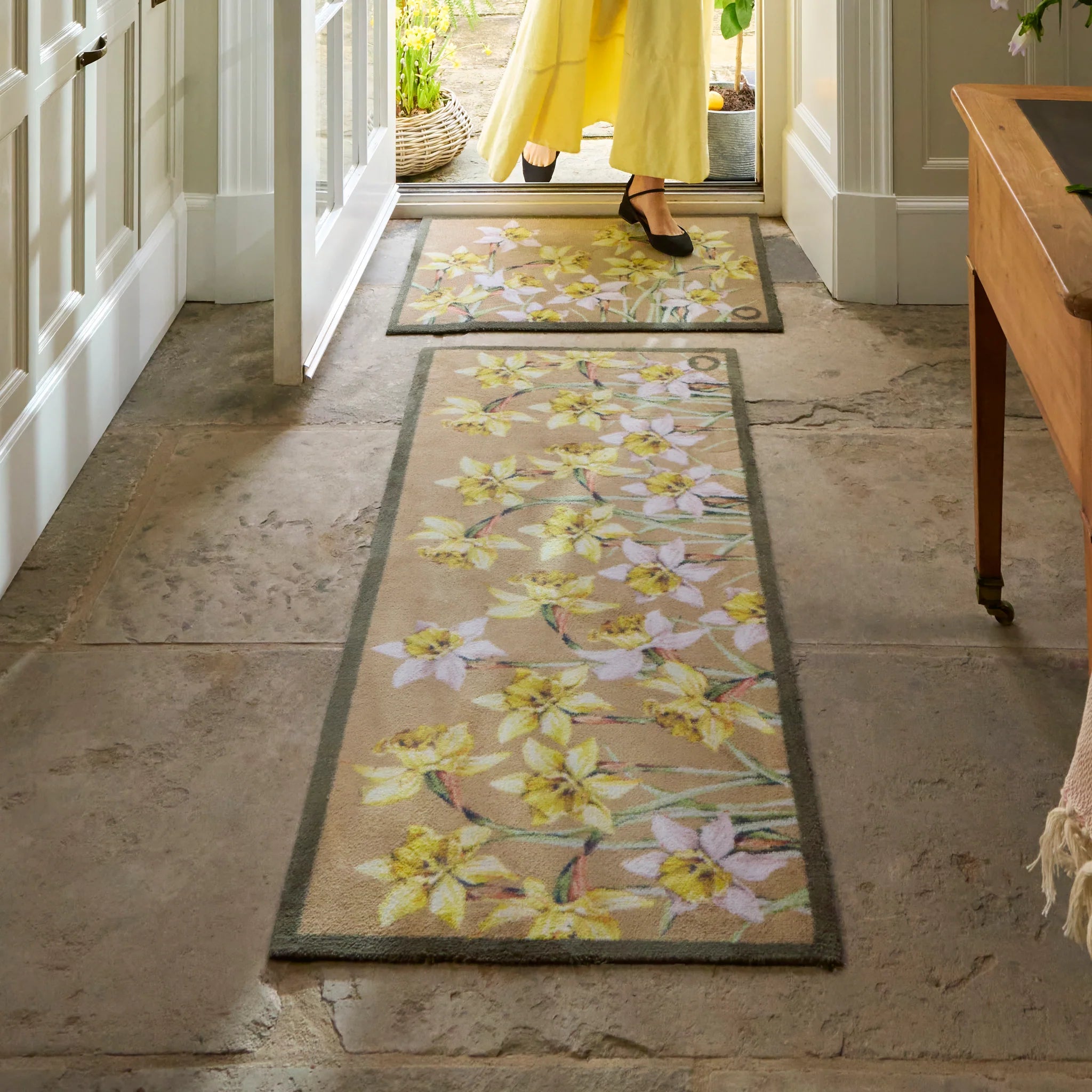 Hug Rug Daffodil Blooms catching dirt at doorway


