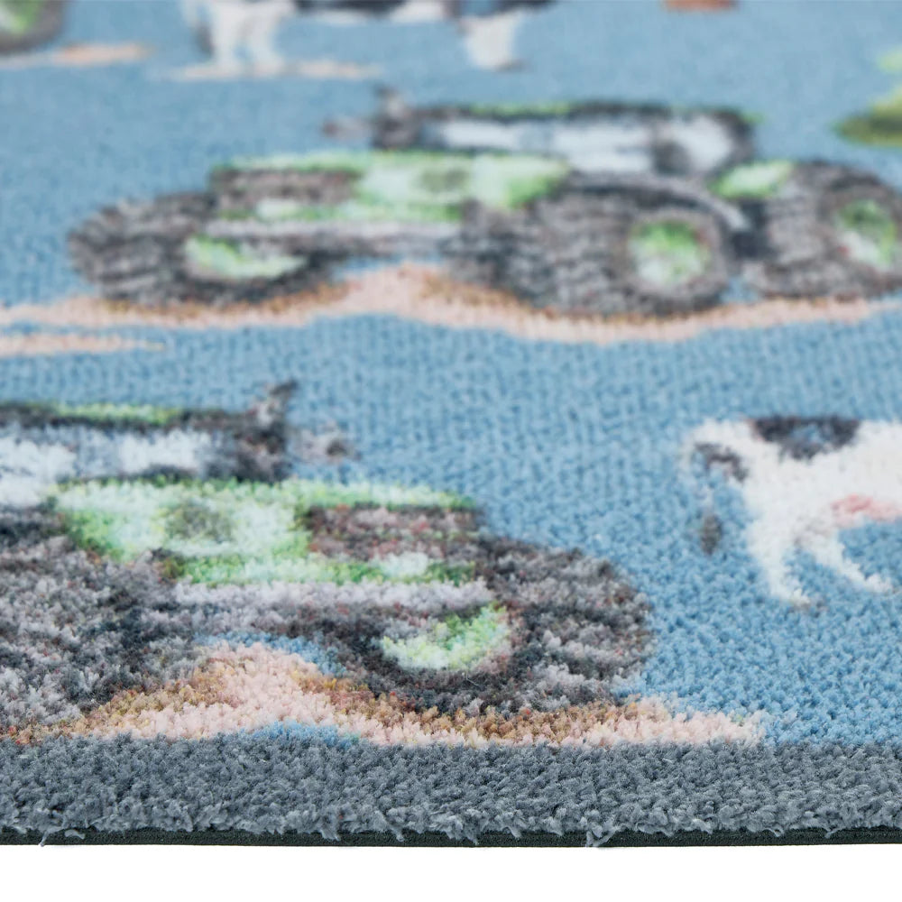 Close-up of Hug Rug tractors and cow illustrations

