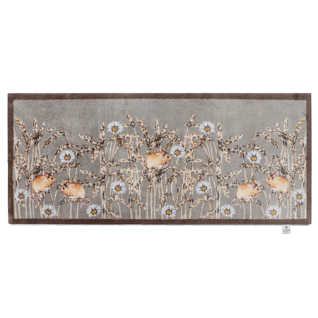 Decorative rug runner with floral and deer design on a gray background