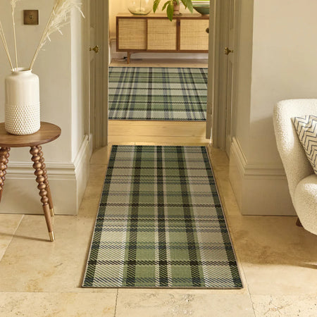 Plaid runner rug in a hallway with a side table and chair.