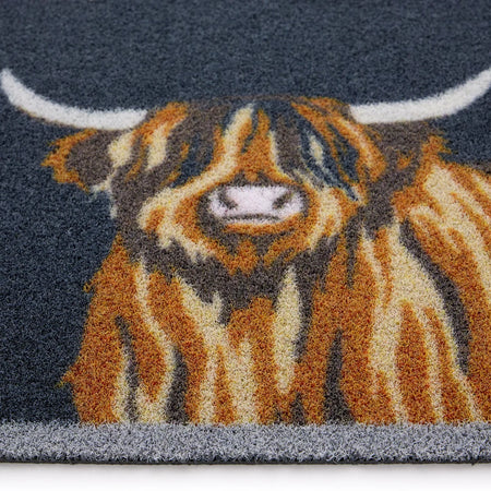 Rug with a design of a highland cow on a dark blue background