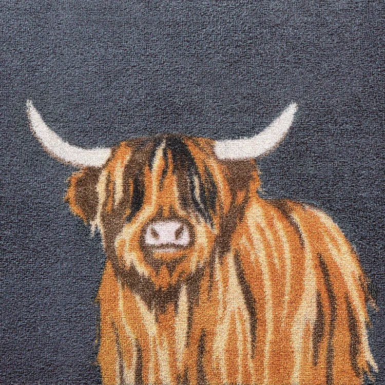 Close-up of Hug Rug Highland 1 Mat featuring rustic Highland cow illustration on absorbent fabric