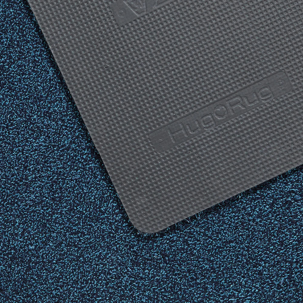 Gray textured mat with 'Hug Rug' branding on a blue textured surface