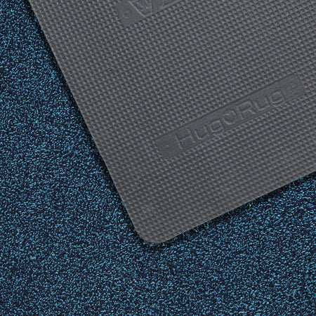 Gray textured mat with 'Hug Rug' branding on a blue textured surface