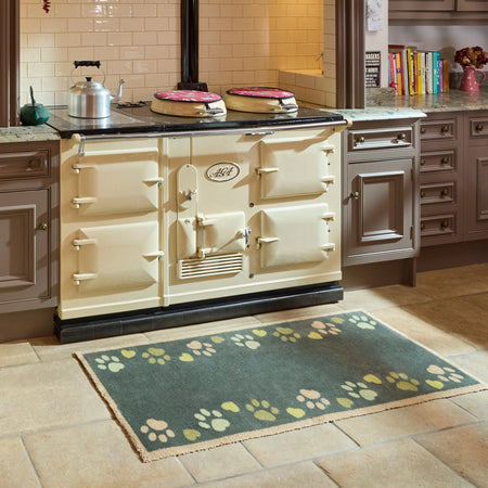 Dark pet doormat with multicoloured paw print pattern

