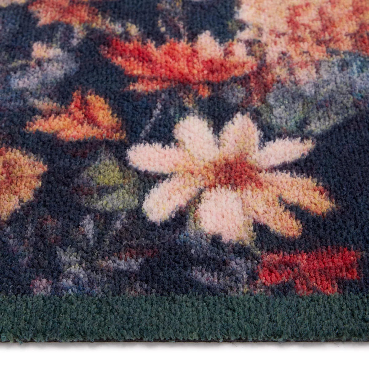 Close-up of a floral patterned rug with a prominent white flower.