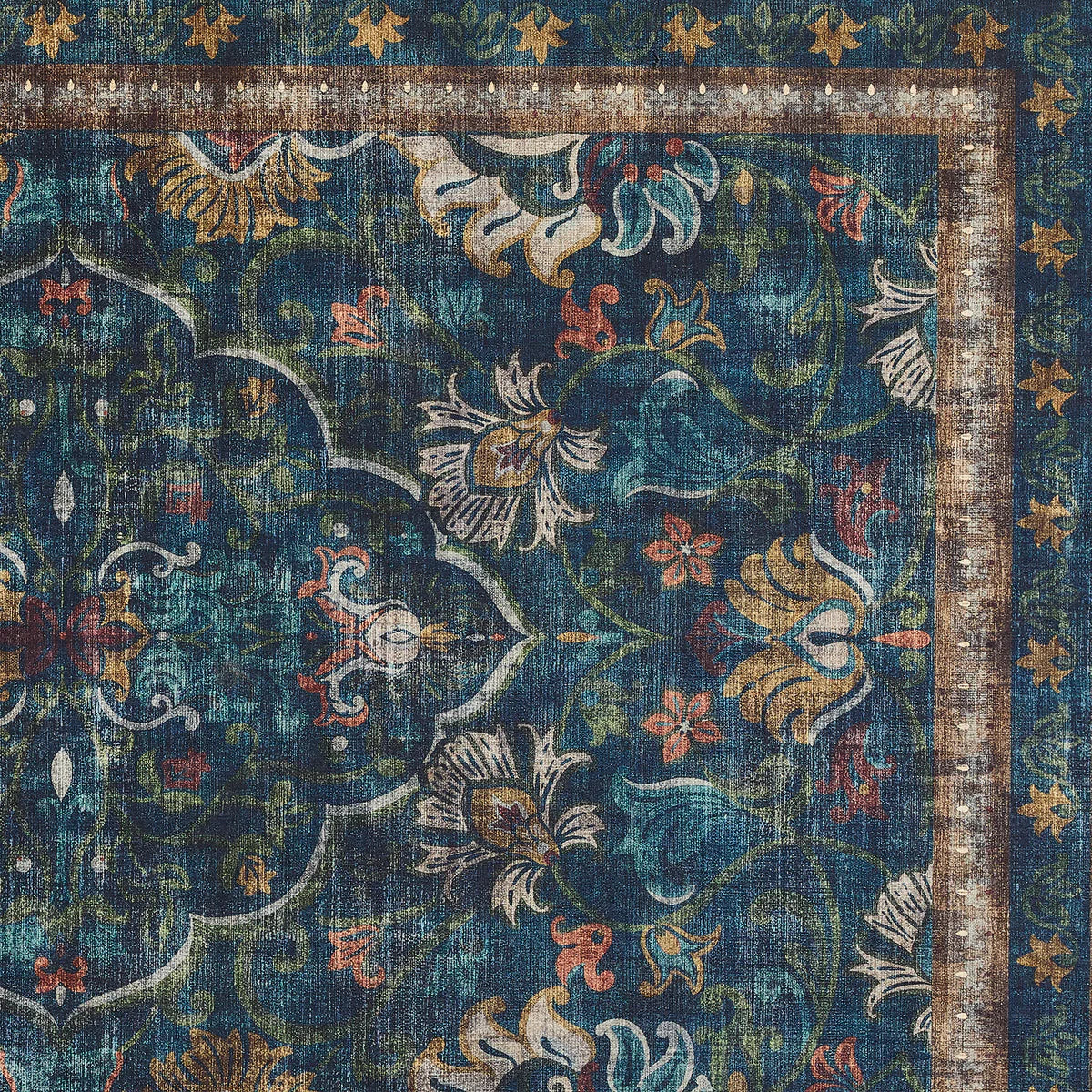 Decorative rug with intricate floral patterns in blue, gold, and red on a dark background.