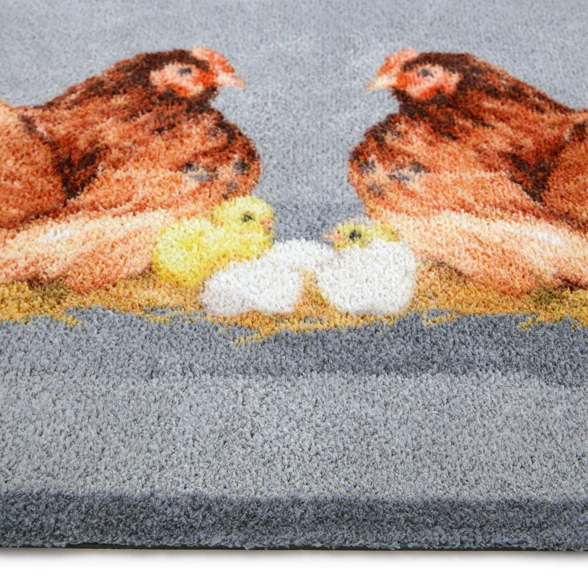 Close-up of Hug Rug hen and chick design

