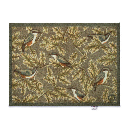 Decorative rug with bird and leaf pattern on a white background