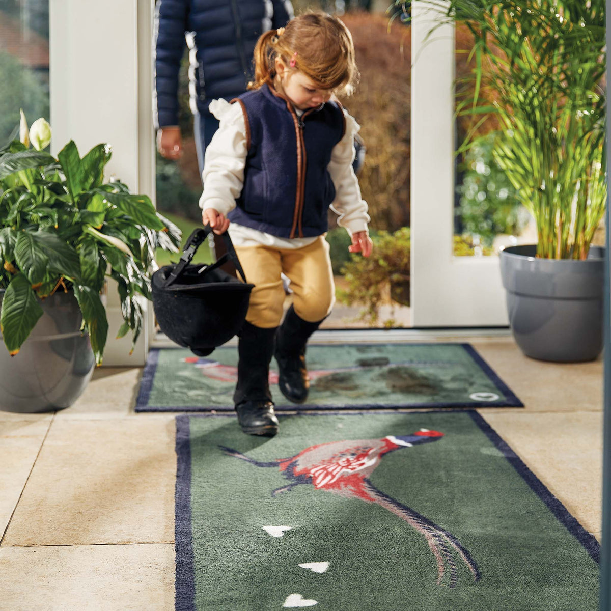 Hug Rug Pheasant Green 2 Barrier Mat placed in a rustic hallway – Perfect for trapping dirt and moisture