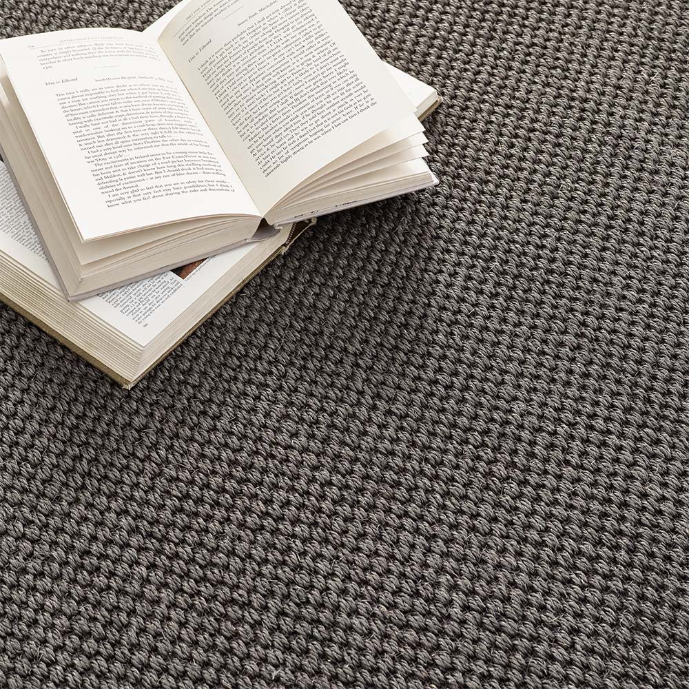 Hand woven grey sisal rug with dark grey stitched edge