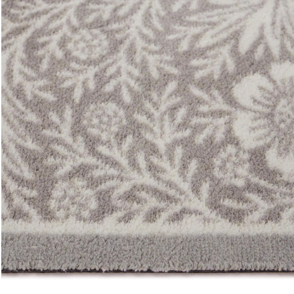 Close-up of a textured gray rug with a subtle pattern