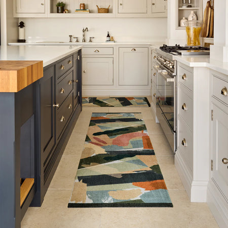 Colorful My Mat Studio Collection Mural runner on a kitchen floor with white cabinets and wooden island.