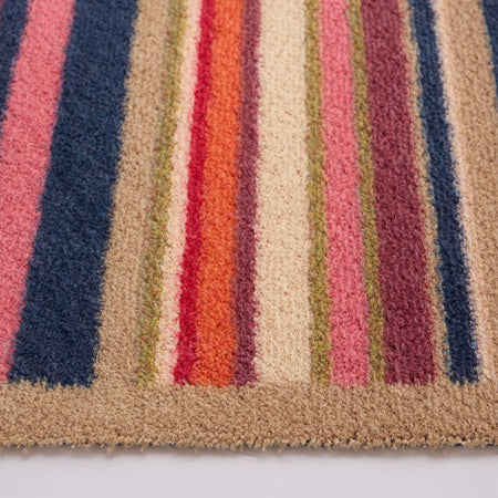 Close-up of a textured fabric with multicolored stripes on a white background
