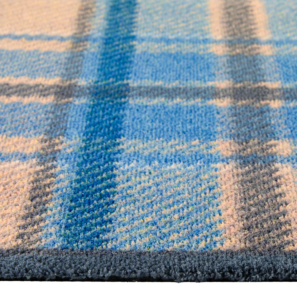 Close-up of Hug Rug classic blue tartan design

