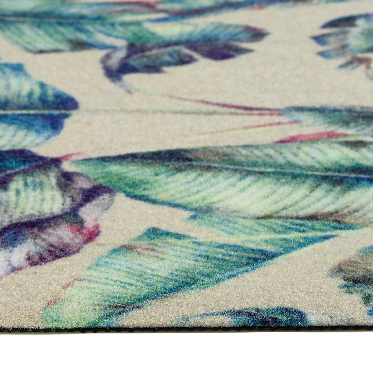 Close-up of Pastel Palms tropical print on durable natural coir fibres – Excellent scraping action to remove dirt