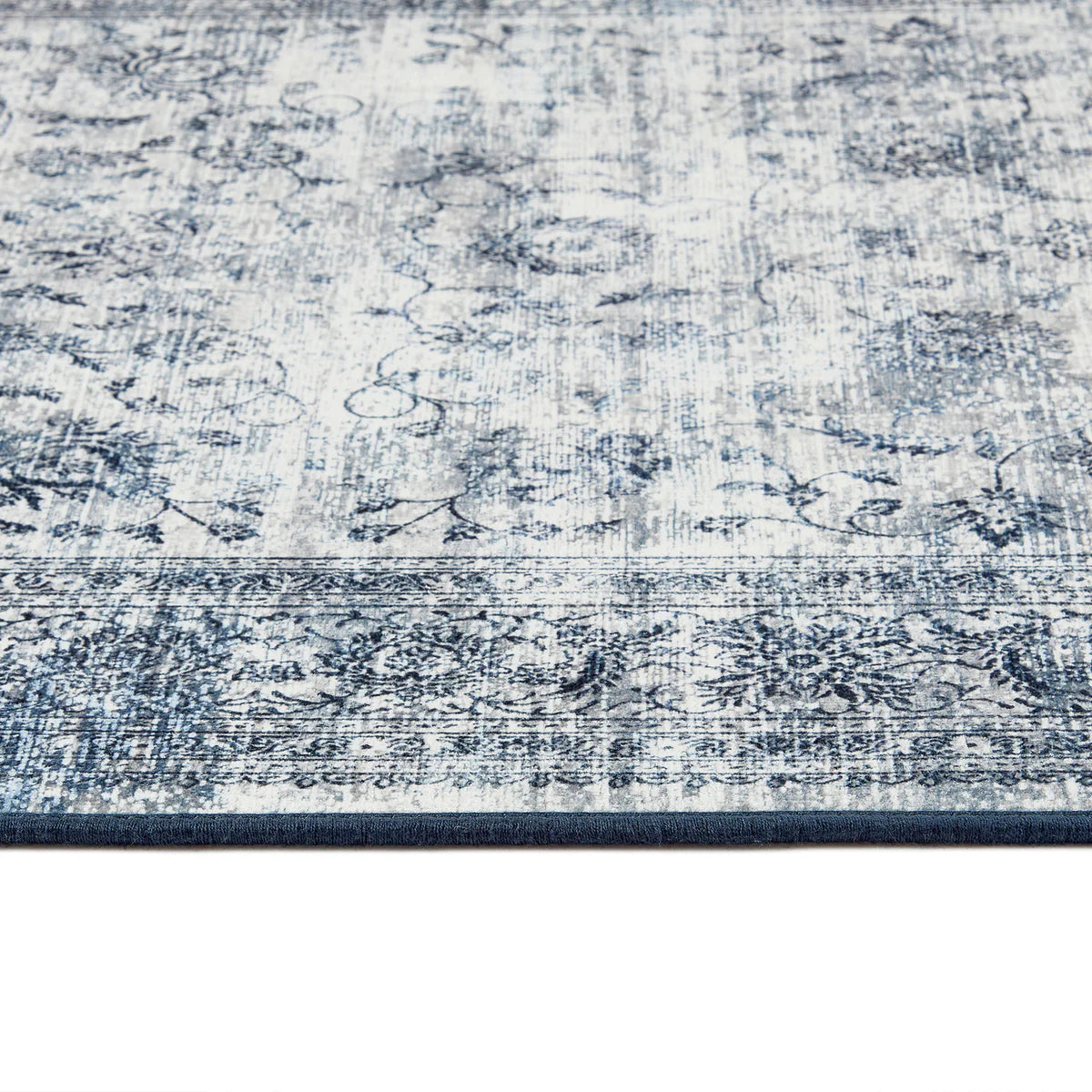 Close-up of a blue and white patterned rug