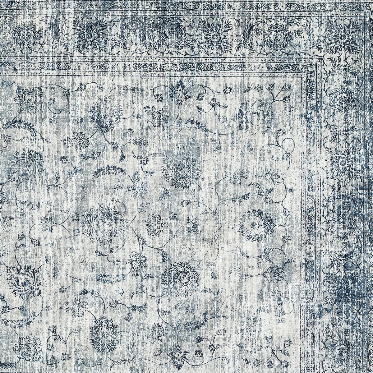 Vintage-style rug with intricate patterns in blue and gray tones.