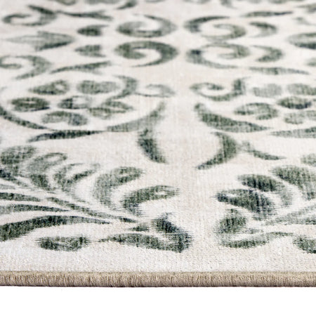Close-up of a patterned rug with green and beige design