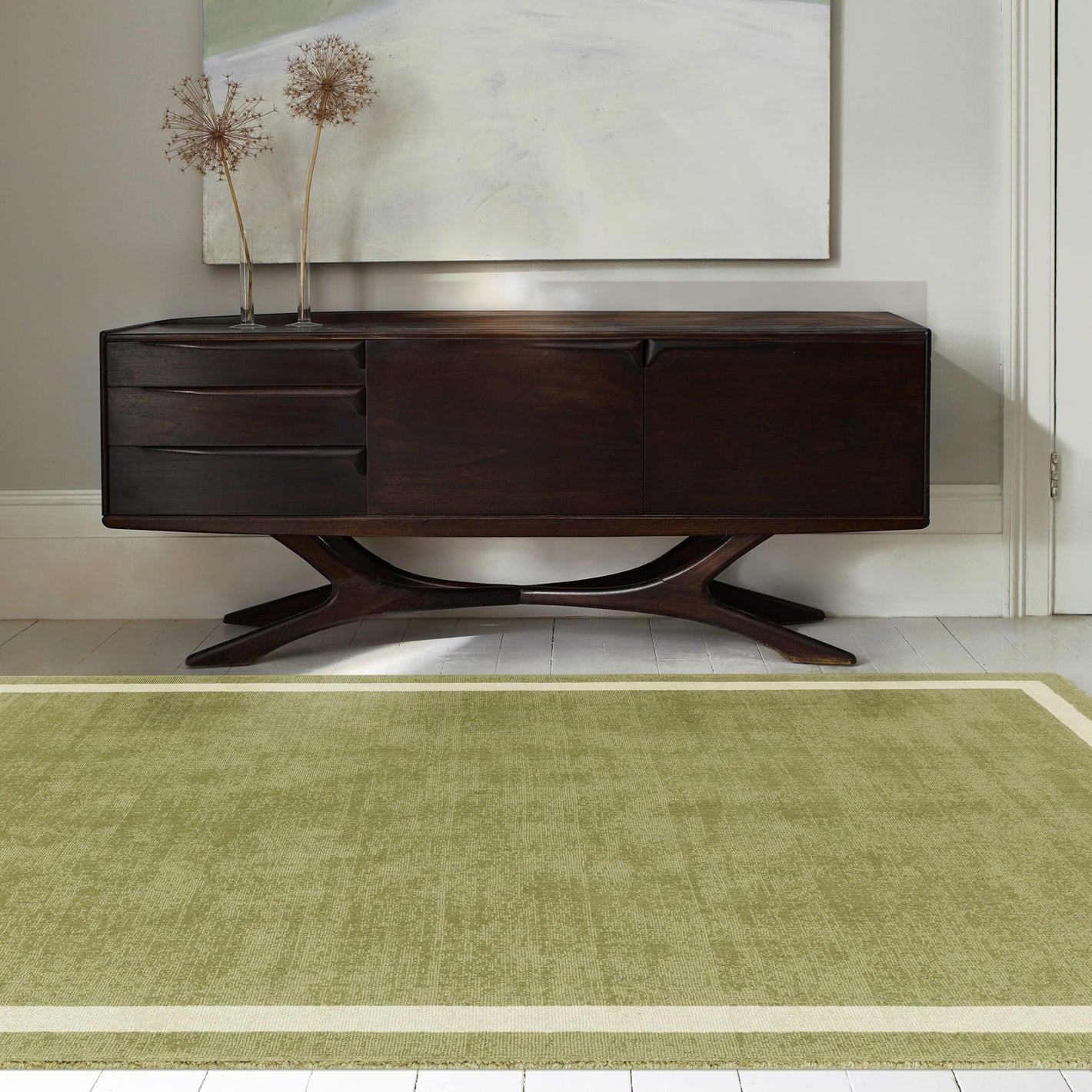 Green wool rug styled in living room


