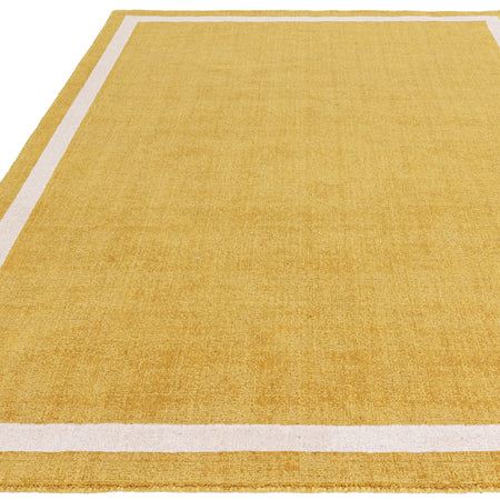 Golden ochre rug styled in bright interior

