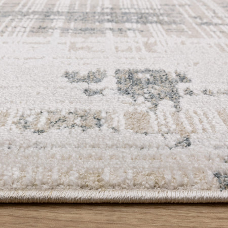 Neutral patterned rug on wooden flooring

