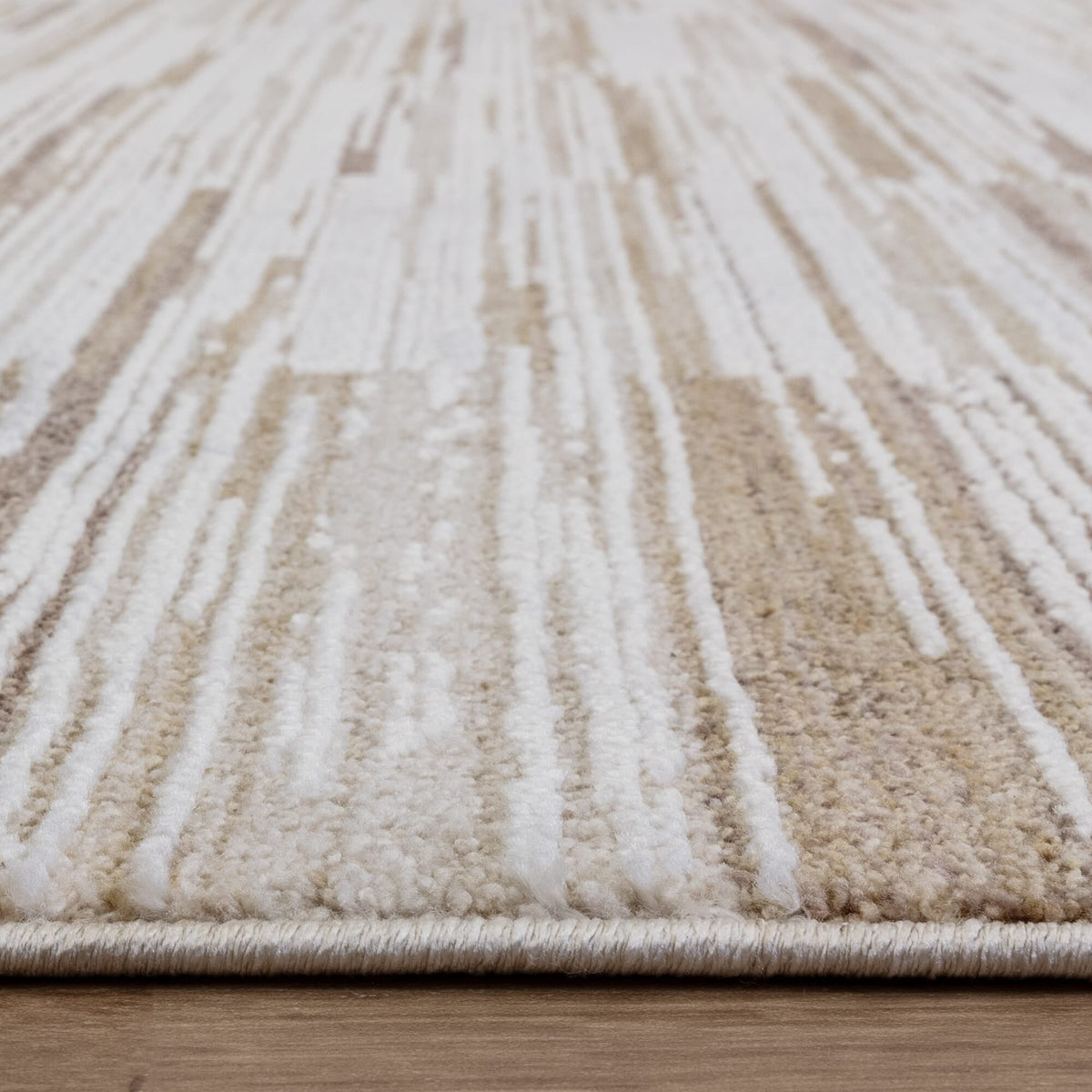 Textured rug on light wood flooring

