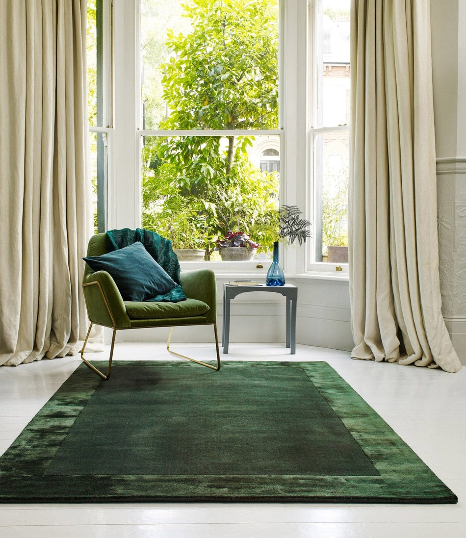 Hand woven rug with green border

