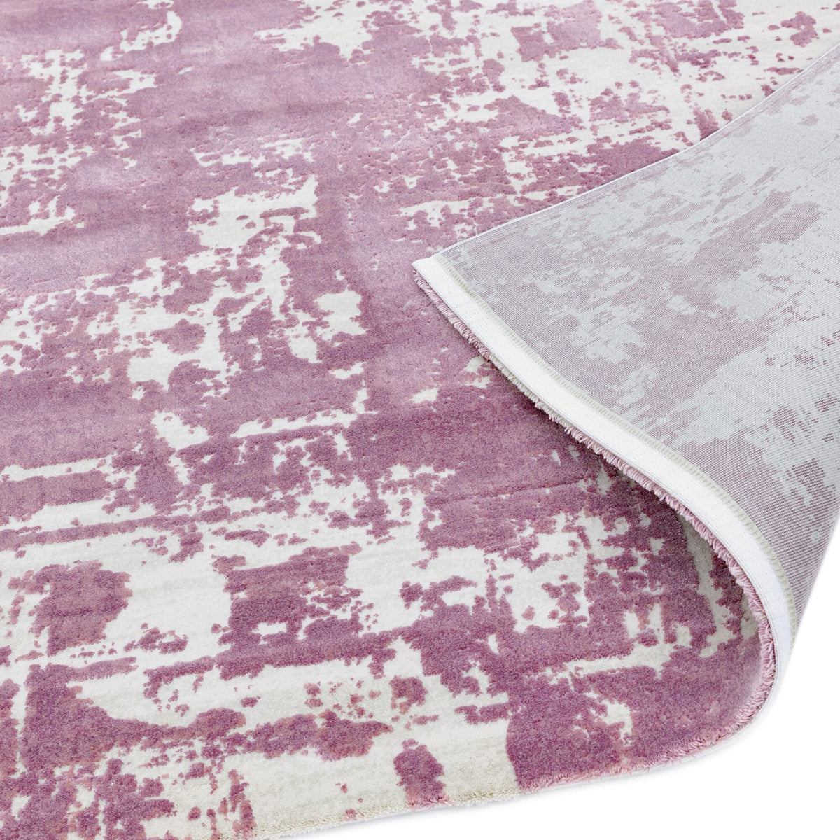 Soft polyester rug with distressed effect showing backing