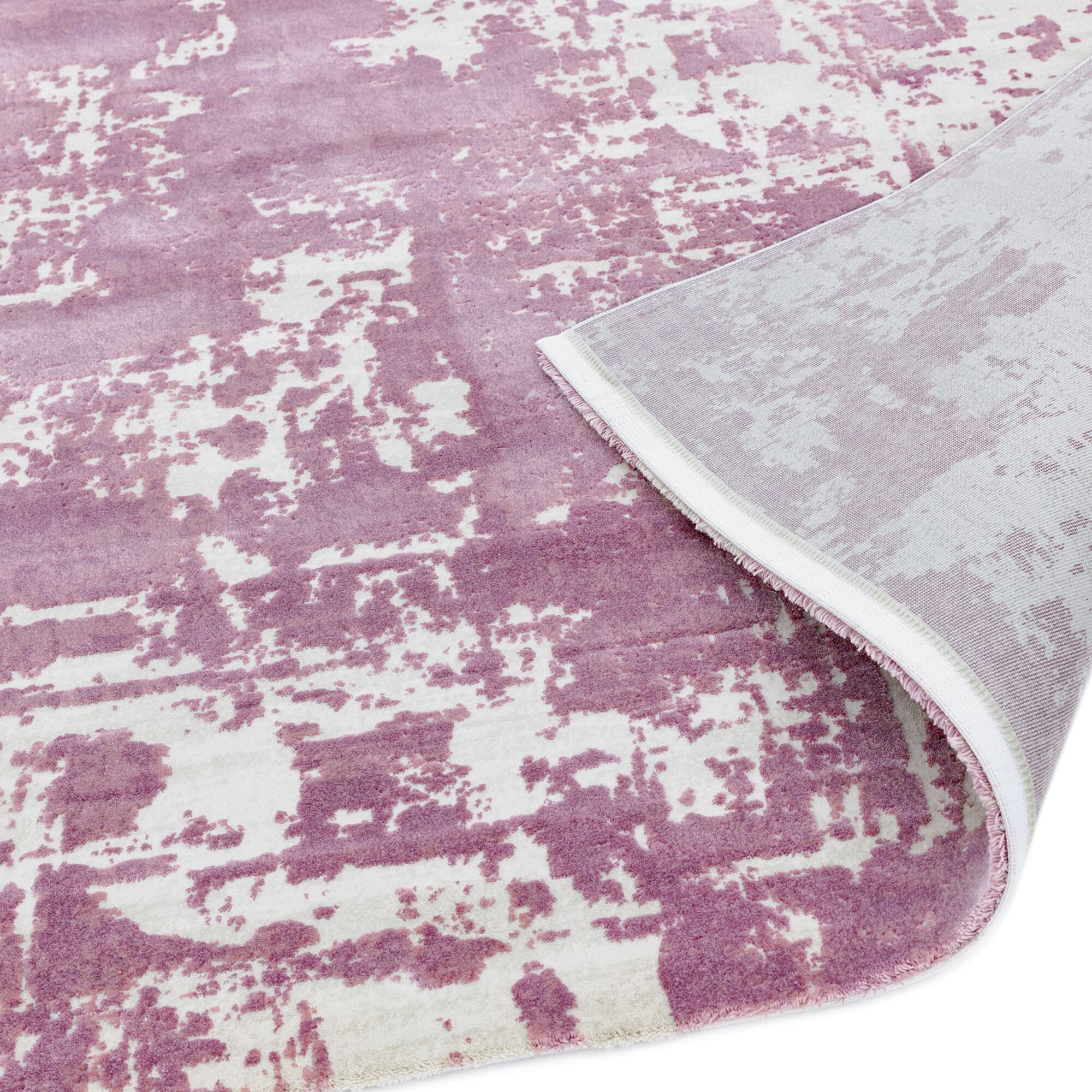 Soft polyester rug with distressed effect showing backing